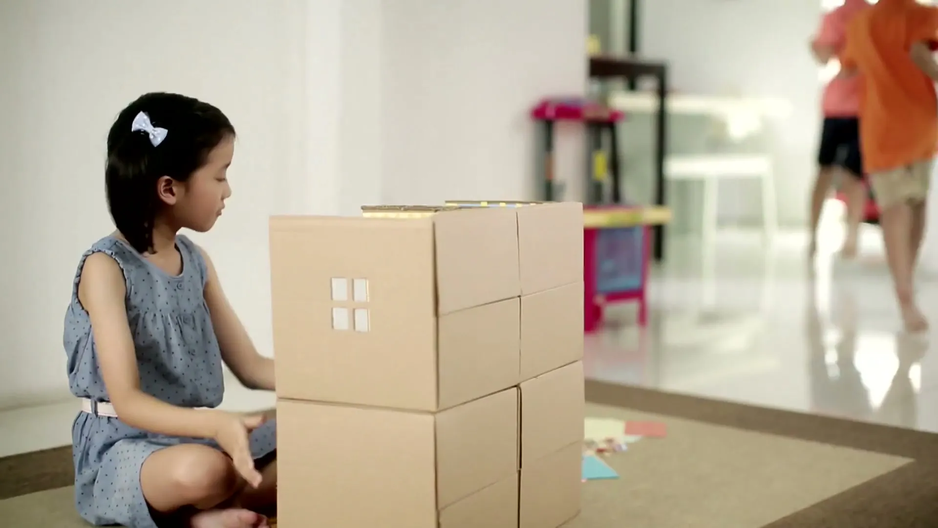 POSB HomeShield ad, a child building a house from cardboard boxes